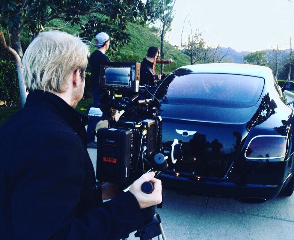 Commercial — camera rig behind a Bentley at golden hour