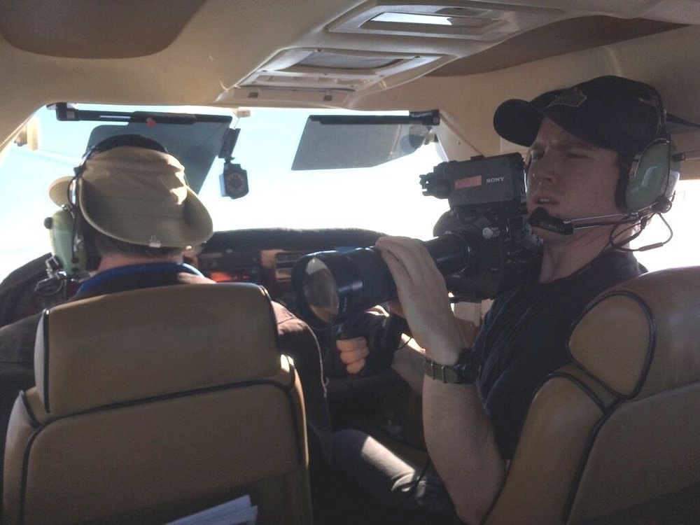 Documentary — camera operator filming from a light aircraft cockpit