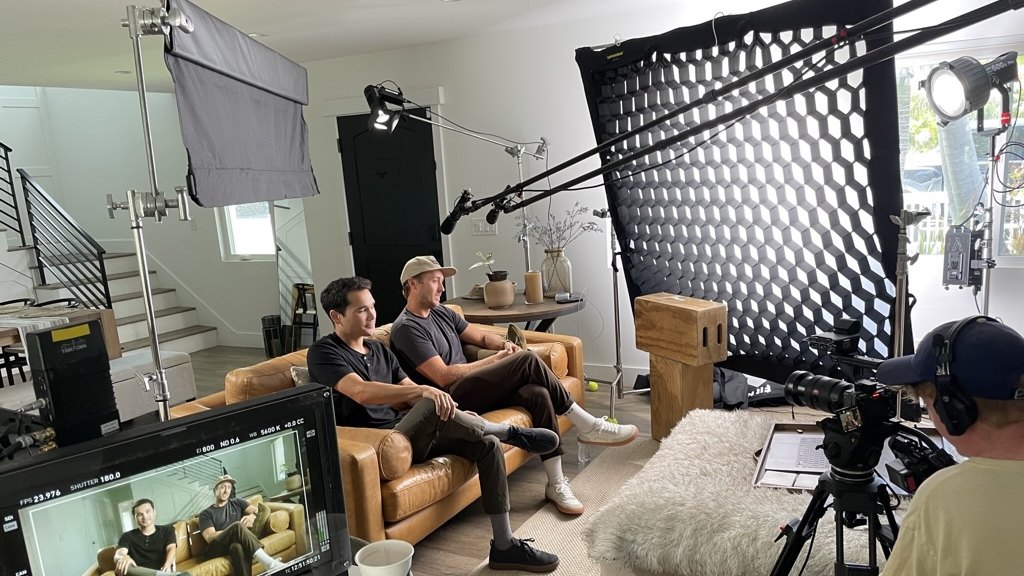 Documentary — the founders on a couch interview, monitor in foreground